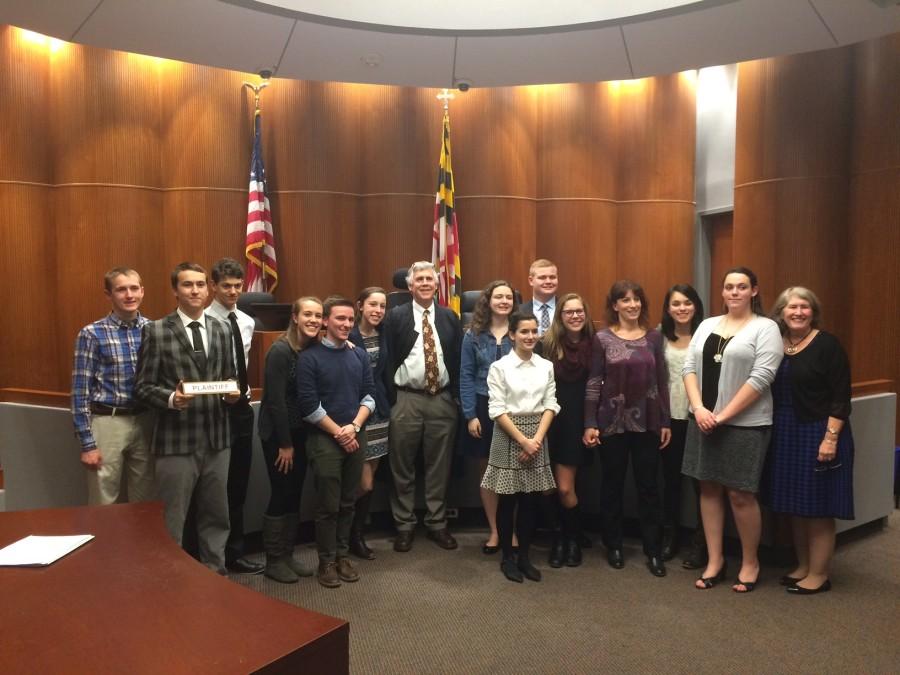 The Mock Trial team poses with their judge after the competition. 