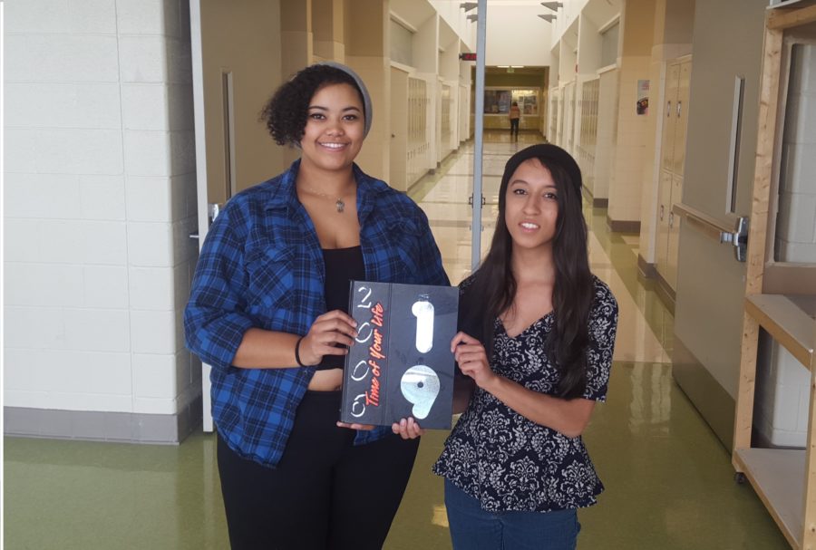 (left to right) Seniors Brianna Pettaway and Kaila Gordon pose with a past yearbook.