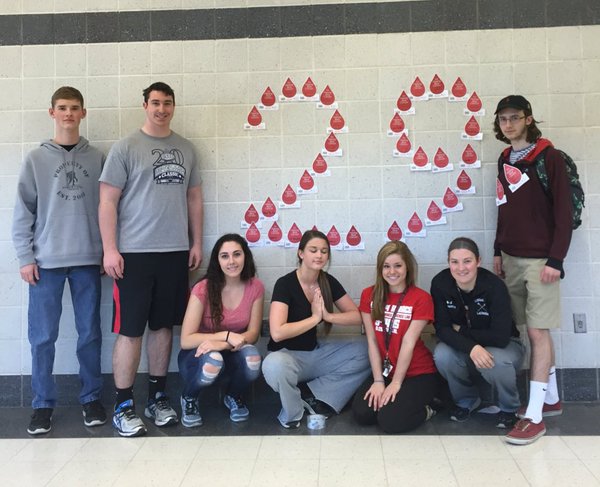 (From left to right) Seniors Carl Powell, Justin Knotts, Susanna Lertora, Lexi Gillum, Olivia DuBro, Sarah Roerty, and Greg Gaydosh pose with the paper blood drops, representing donations toward the Leukemia and Lymphoma Society.