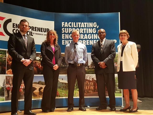 Robert Winter poses with the superintendent and judges of the Startup Frederick Competition