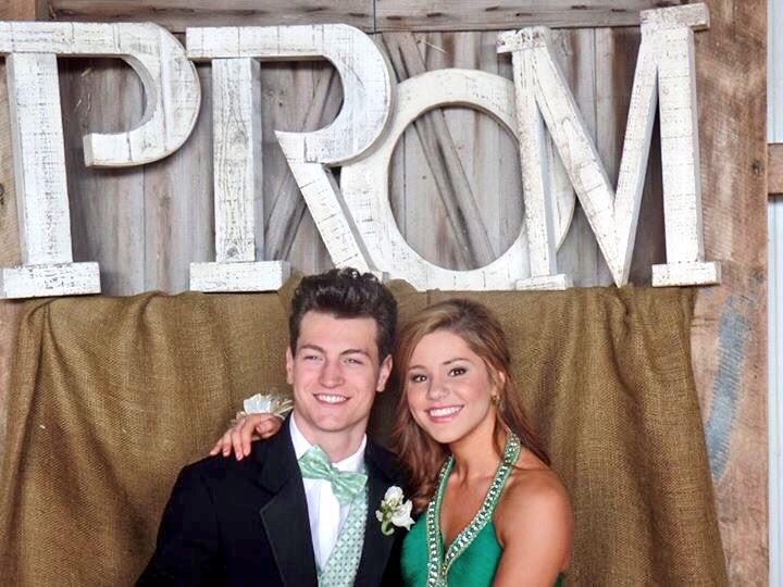 Olivia DuBro and her date Jackson Knight pose in Tanner Ridgely's  prom-decorated barn before the dance.