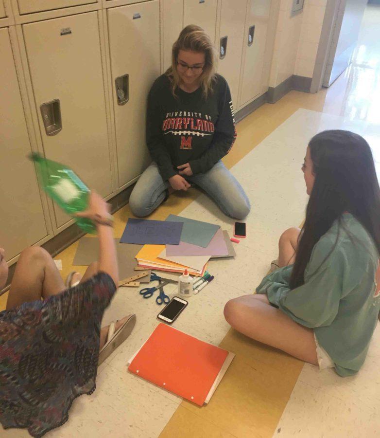 (from left to right) Lily Weaver, Makayla Glock. and Ellie Miley work together to construct their bottle rockets