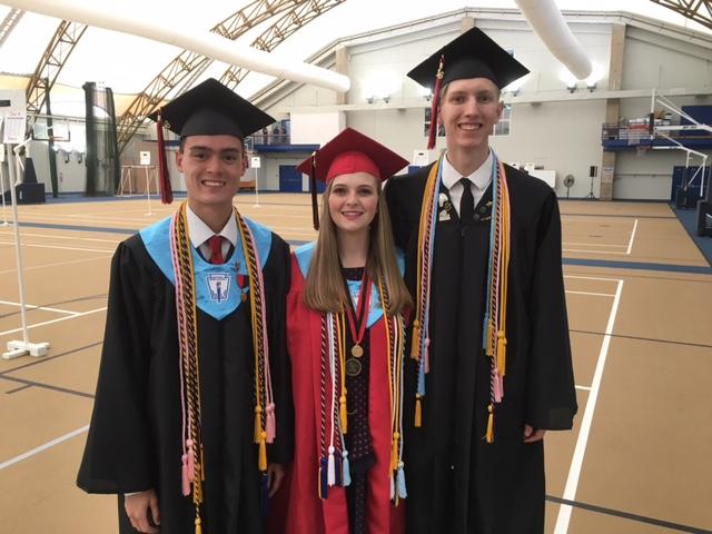 Student speaker, Noah Ismael, and duet singers, Abby Weinel and Kylan Connolly, pose for a picture before graduation.