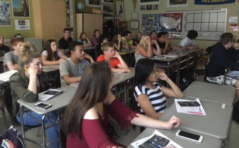 Ms. Hendis government class watches a movie educating the students  about the dangers of racism. 