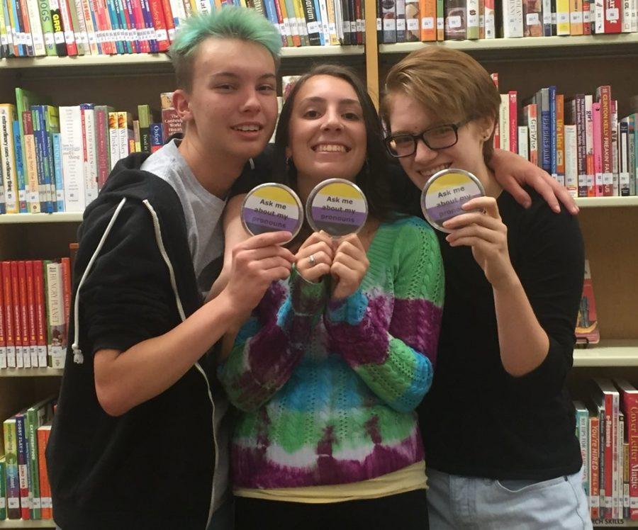 Jack Adams, Avalon Gravley, and Beau Cameron show off their Ask me about my pronouns buttons.  