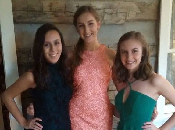Martha Madrid, Cassia Connolly, and Eileen Rich prepare for the homecoming dance.