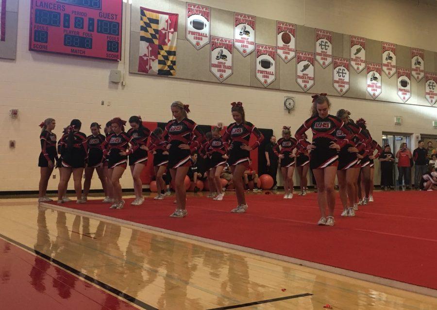 The varsity cheer team performs at the pep rally.