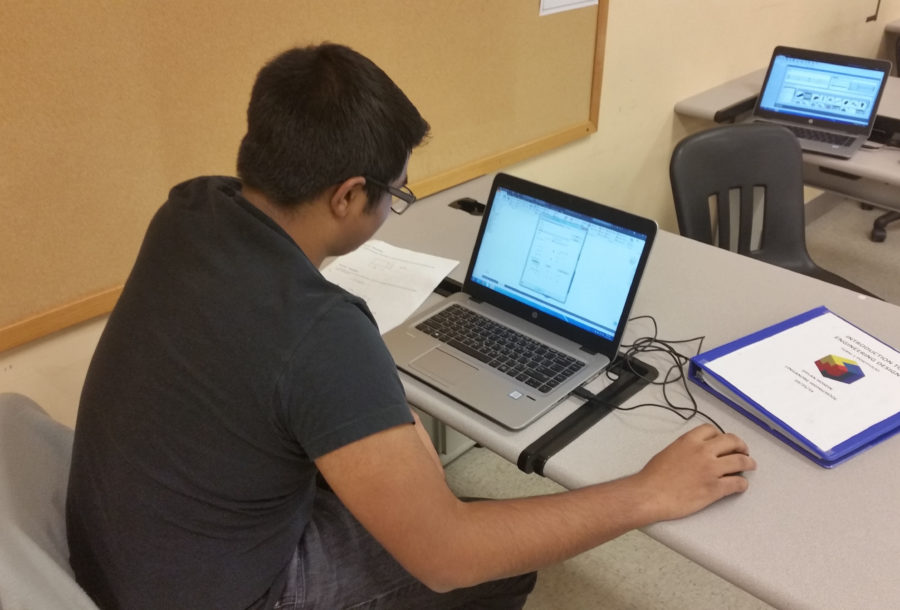 Dylan Hosein works on his train using computer software program Inventor.