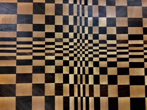 An example of a wooden cutting board constructed from walnut and maple wood, made by senior Micah Hewitson