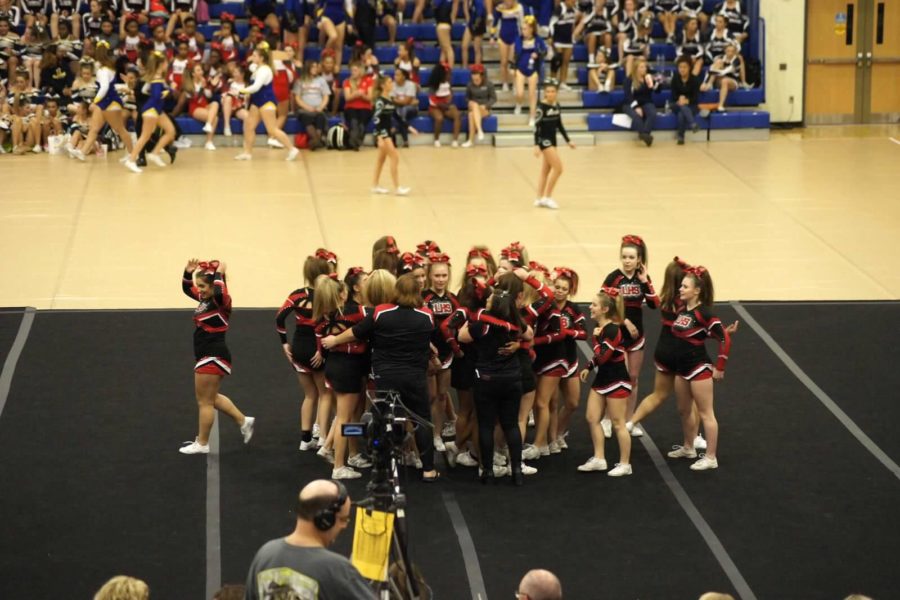The coaches run onto the floor and hug the girls after a killer performance.