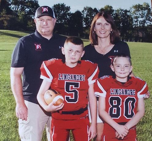 Coach Easterday with her husband and two sons before their 2016 football season. 