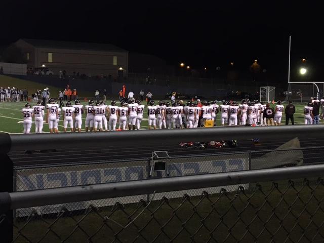 Lancers football team lines up on the sideline at Fridays game