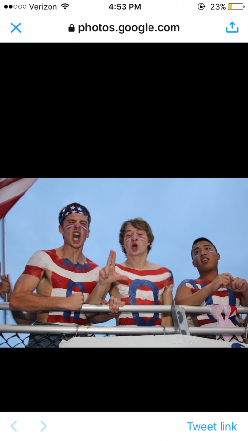 Austin Lohneis and Sam Honchalk get the crowd pumped up for a football game.