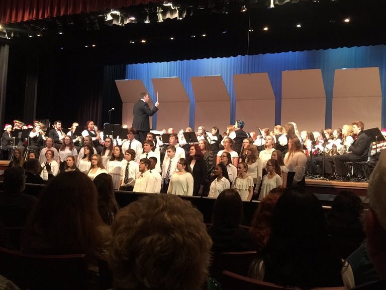 Erika Katsumoto, in the front right behind the concert choir, performs with the concert band and choir during the annual holiday show.