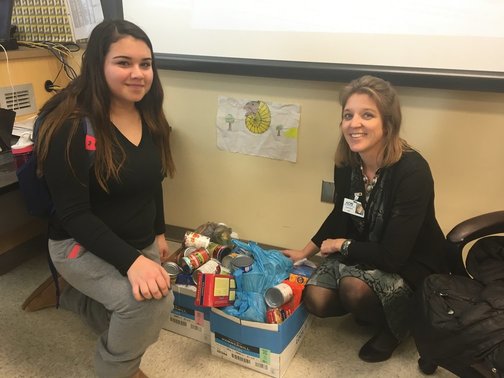 Mrs. Byrd and SSL Isis Suarez with boxes of canned food for the Hunger Hits Home project.