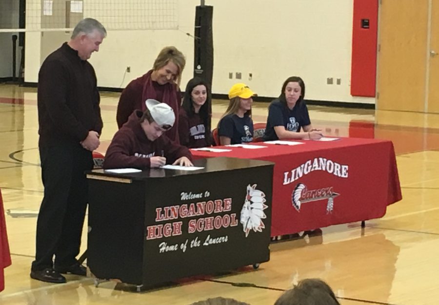 Noll Stieren, surrounded by parents Dave and Trish Stieren, signs his letter of intent to play football for the Salisbury Seagulls