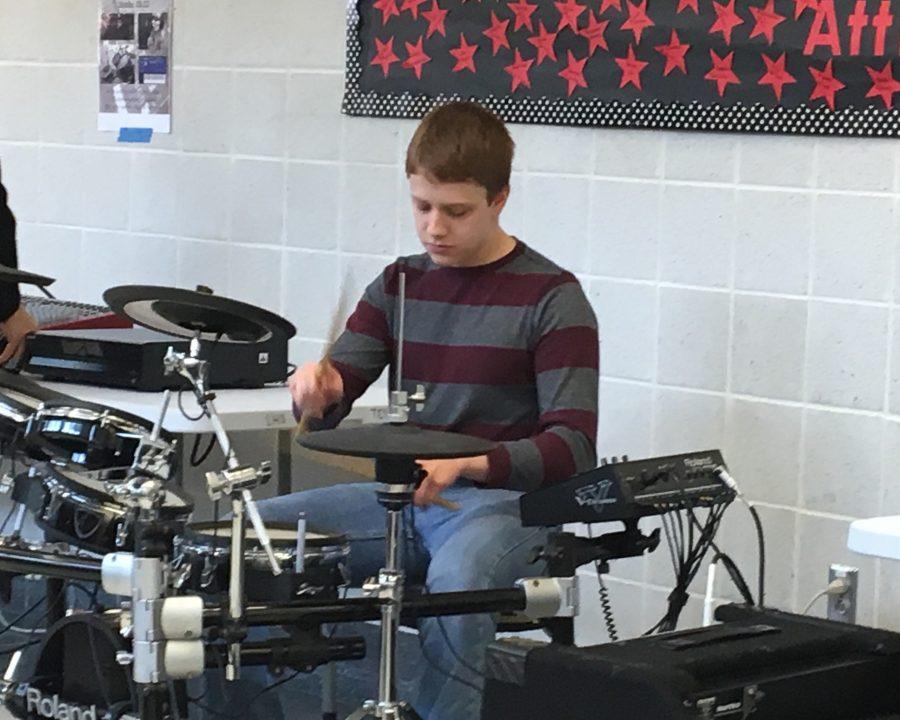 David Wallace plays the drums during lunch.