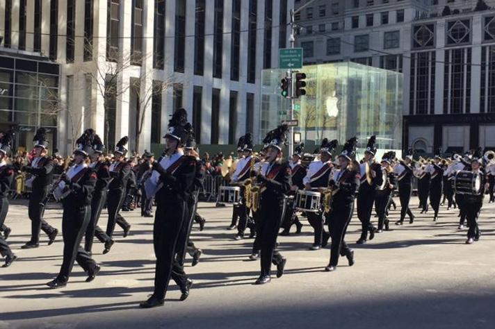 The band marches on 5th Avenue outside the Apple Store. 