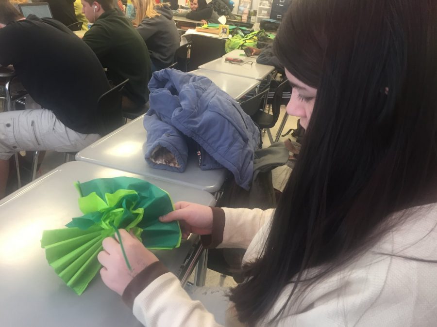 Katie Quirolgico works on creating her paper flower