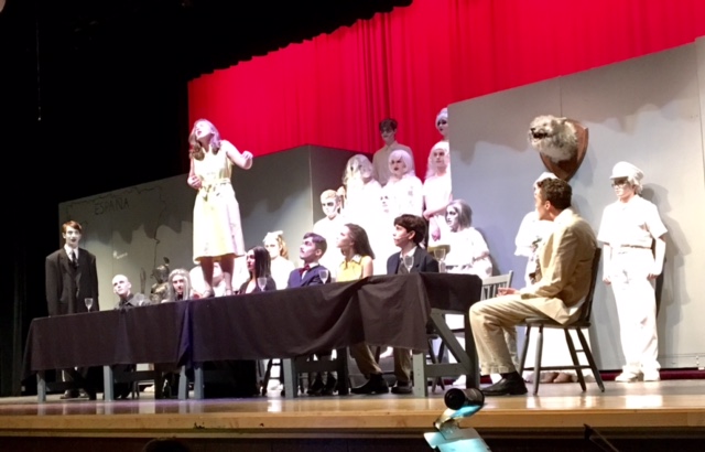 The cast of The Addams Family watches as Sarah Maerten performs Waiting during dress rehearsals.