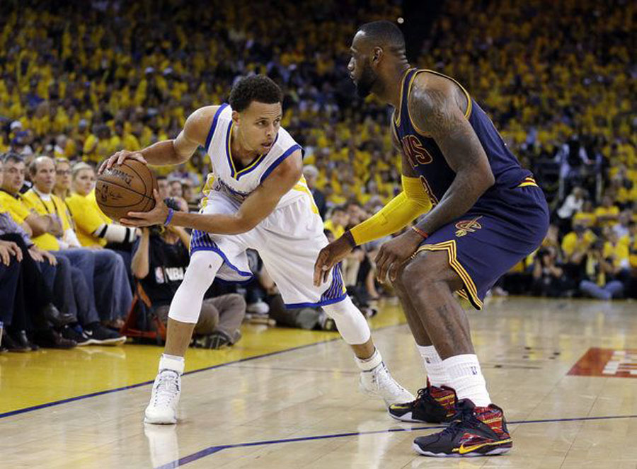 Golden State Warriors guard Stephen Curry, left, is guarded by Cleveland Cavaliers forward LeBron James during the second half of Game 5 of basketball's NBA Finals in Oakland, Calif.