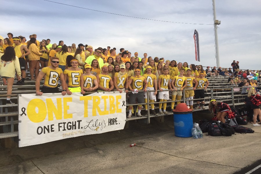 Tribe members and student section yellowed out for the fight against childhood cancer.