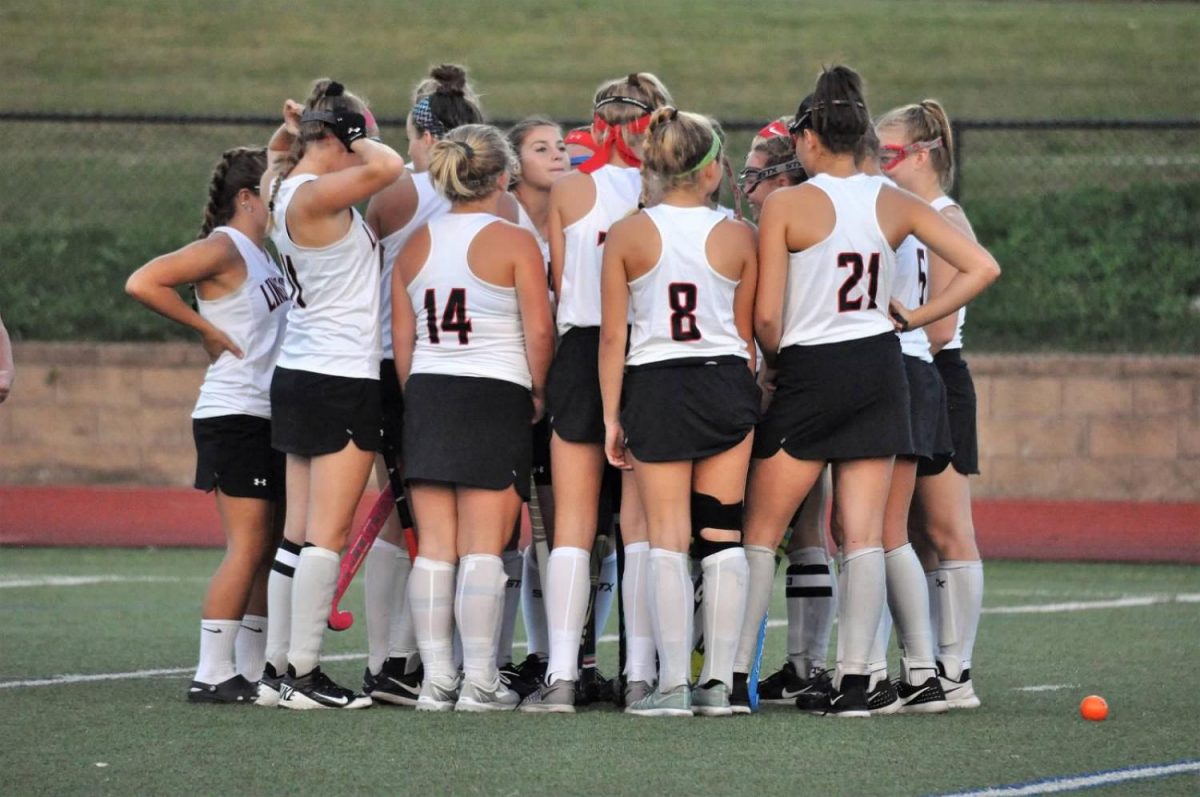 Varsity field hockey gathers together before a game.
