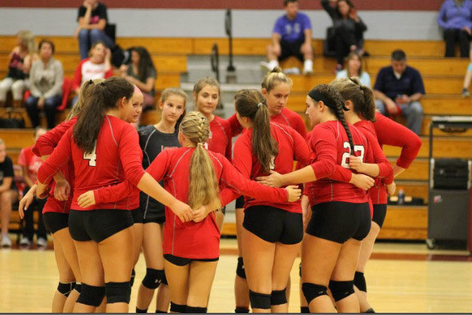 Varsity volleyball huddles before the North Hagerstown game. 