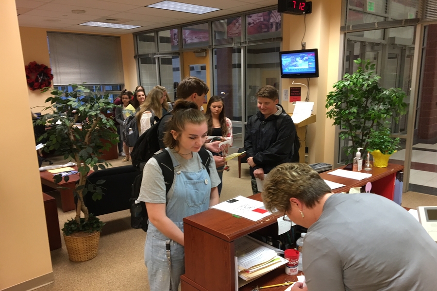 Presley Dougherty, junior, in line to submit her parking permit application to Mrs. Debbie Day. 
