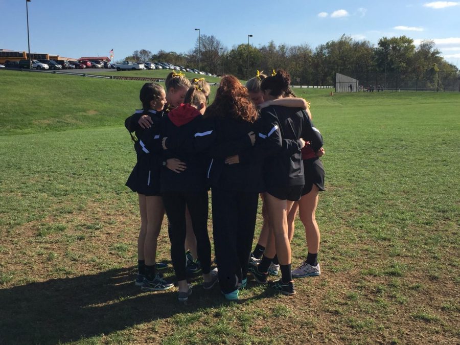 The girls team huddles at the starting line before the race. 