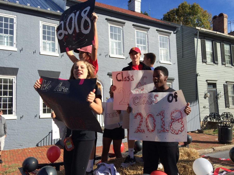 Members of class of 2018 stand on a float in the Homecoming Parade 2016.