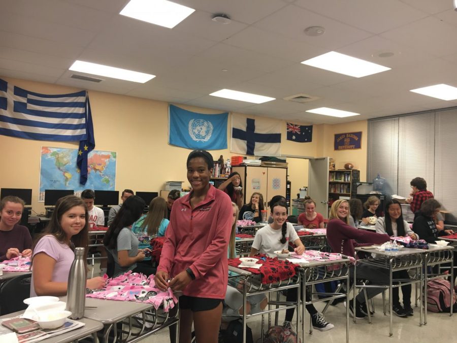 Key Club members work on making cat blankets for the People United for Rescue and Rehabilitation (P.U.R.R.) of West Virginia.