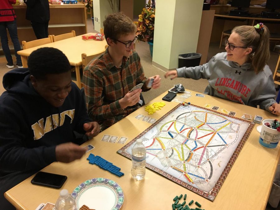 (From left to right): Devin Barge,  Jack Watsic, and Brenna Lindsay play Ticket to Ride.