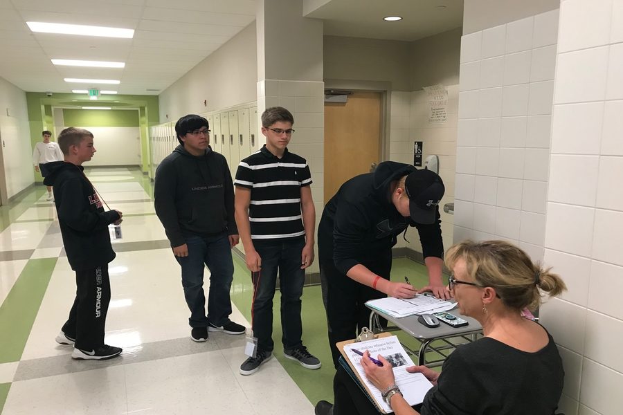 Mrs. Natalie Rebetsky volunteers to monitor the restroom during period four. Students sign in and out of the bathroom.