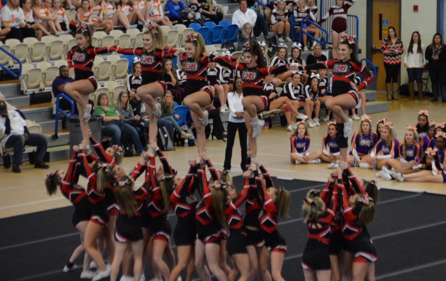 Varsity cheer hitting their stunts during the state performance.