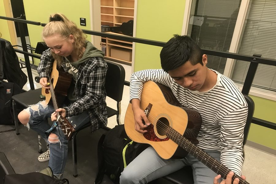Felix Zarate and Madison Riley practice guitar in Mr. Lloyds third period class.