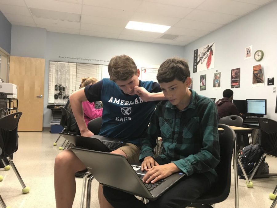 Jason Byrd and Riley Glynn collaborating on their story about creative writing.
