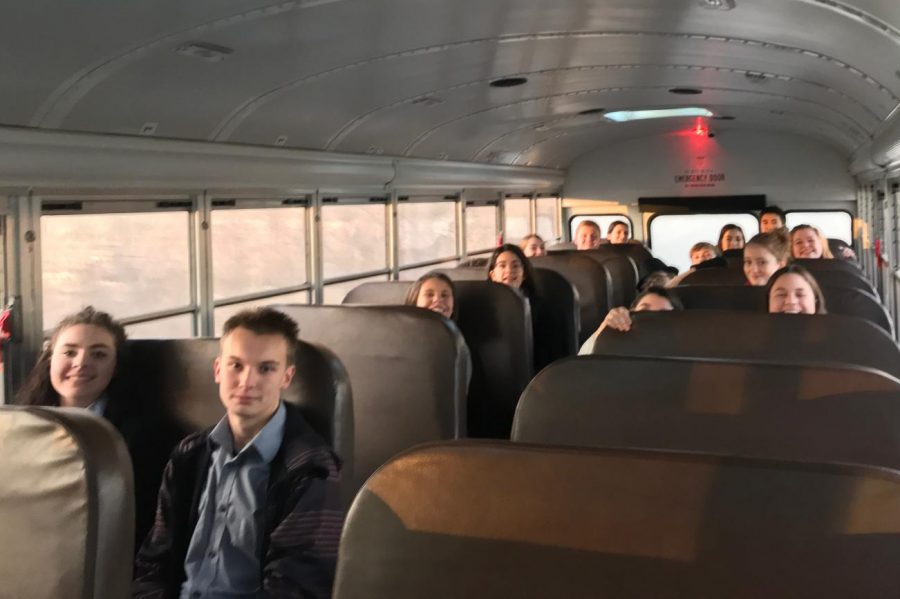 The mock trial team races on the bus to the trial to make it on time.