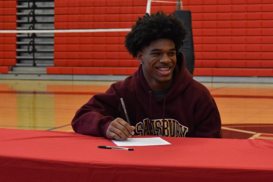 All smiles for Zamare as he signs his National Letter of Intent.