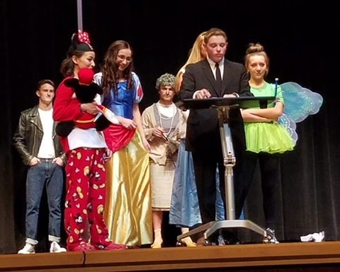 Joel Tate dressed as Walt Disney for his entrance.