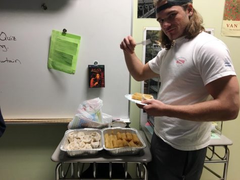 Junior Alex Gresh serves himself some dumplings and egg rolls.