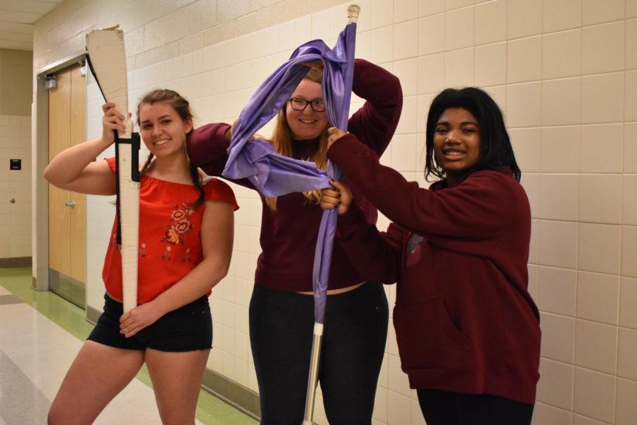 Caroline John, Payton Hull, Geneva Tecle use color guard props to show their enthusiasm for the last 19 days.