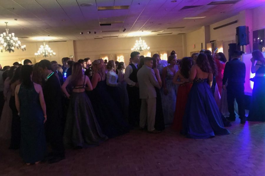 Students gathering around as Prom Queen and King are announced. 