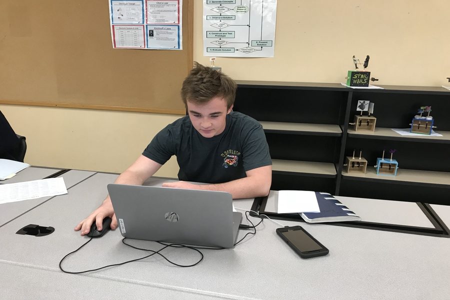 Chris Eastlake works on his computer in Mr. Greenes class.