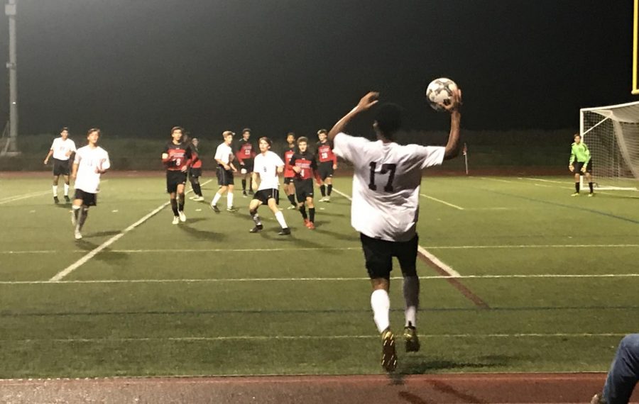 Varsity soccer defends an Oakdale throw in during the final moments of the game.