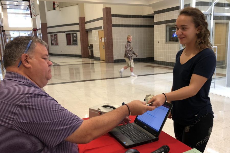 Megan Burr purchases homecoming tickets.