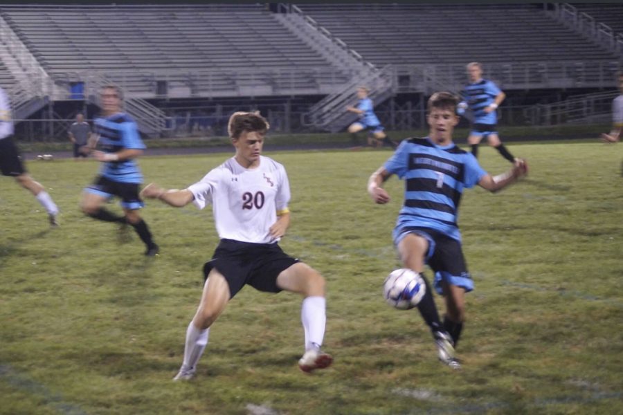 Senior centre-back, Lukas Snyder goes in for a tackle against Westminster attacker