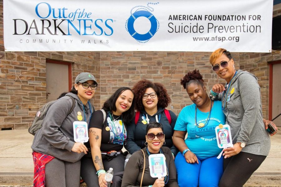 Out of the Darkness Walk 2017 participants pose in front of banner.
