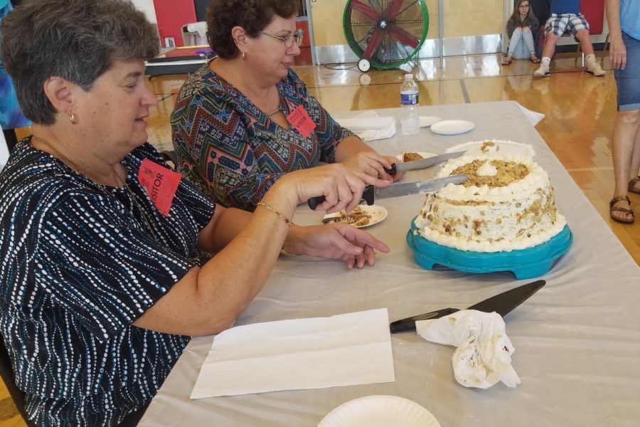 Cheryl Lenhart and Denise Shriver cut into some of the cakes entered in the competition.
