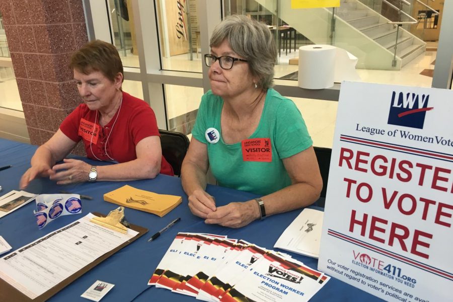 Mary Beth Coker and Betty Mayfield run the League of Women Voters registration table during lunch shifts.